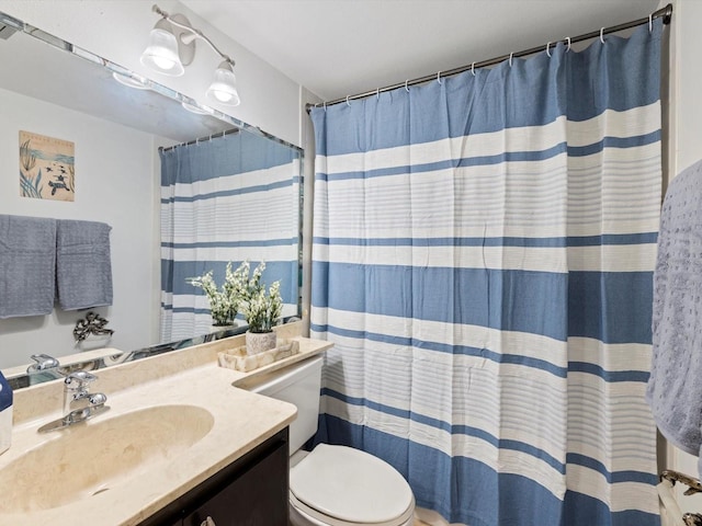 bathroom featuring vanity, toilet, and a shower with shower curtain