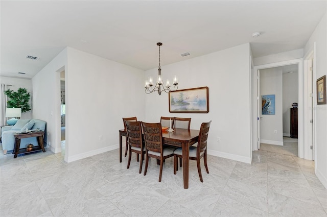 dining space with an inviting chandelier