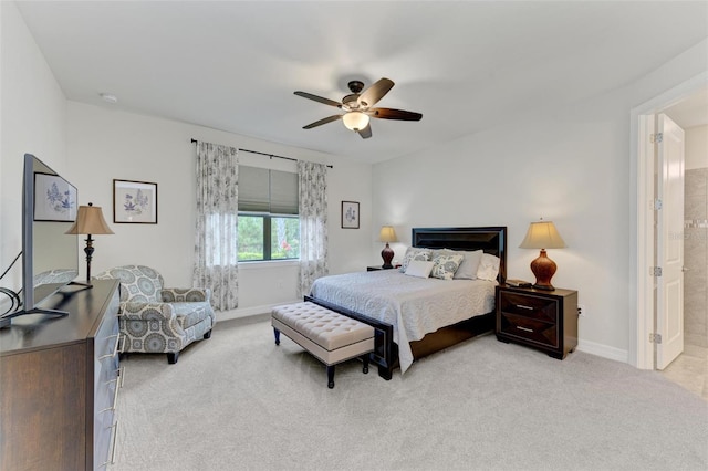 carpeted bedroom featuring ensuite bath and ceiling fan