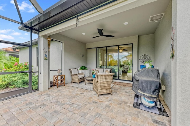 sunroom / solarium featuring ceiling fan