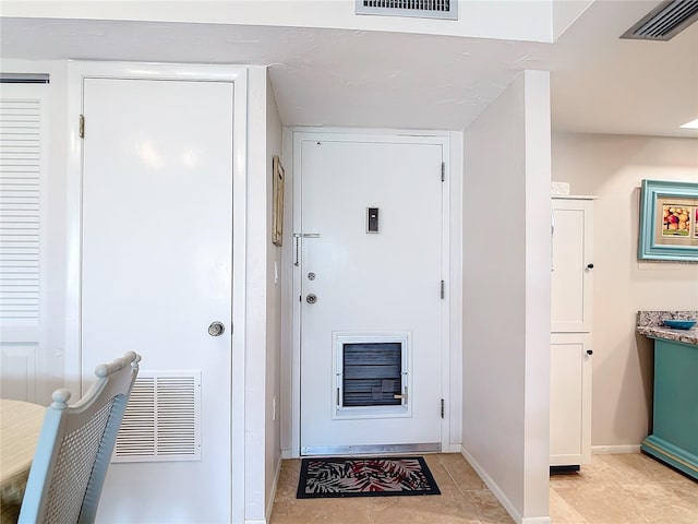 doorway with light tile patterned floors