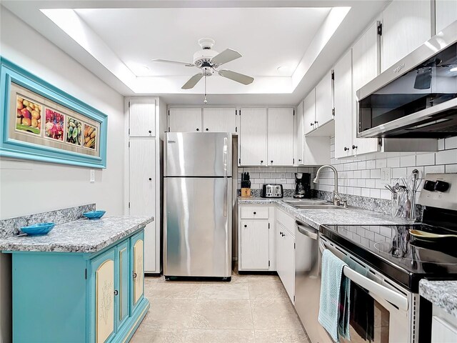 618 Bird Bay Dr S Unit 202, Venice, FL 34285 - kitchen with tasteful backsplash, a raised ceiling, a sink, and stainless steel appliances