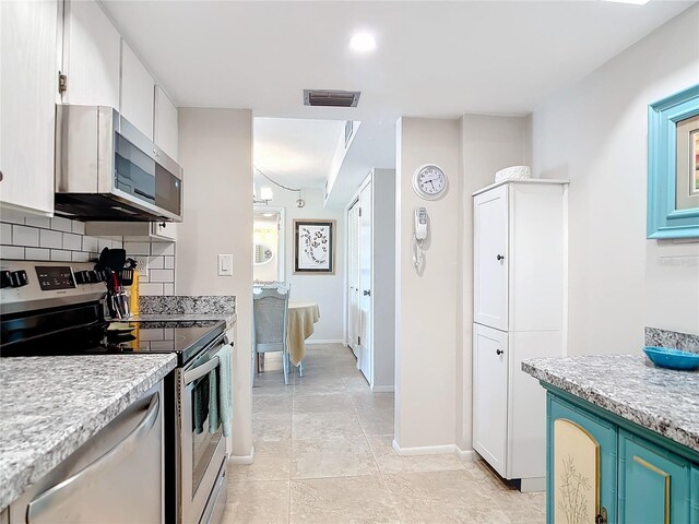 618 Bird Bay Dr S Unit 202, Venice, FL 34285 - kitchen with backsplash, light countertops, stainless steel appliances, and visible vents