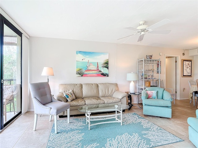 living room featuring ceiling fan, plenty of natural light, and light tile patterned floors