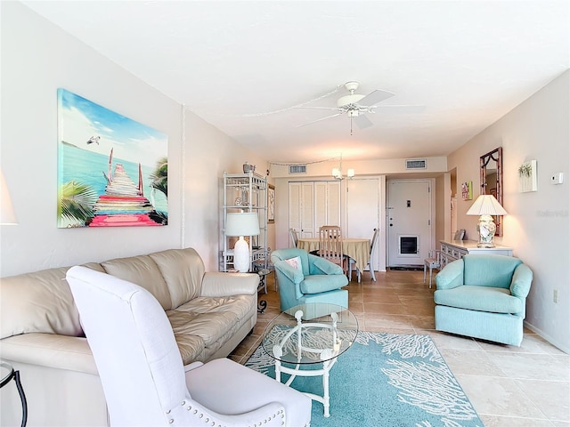 618 Bird Bay Dr S Unit 202, Venice, FL 34285 - living room featuring light tile patterned floors, ceiling fan with notable chandelier, and visible vents