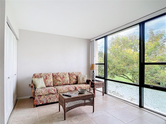 618 Bird Bay Dr S Unit 202, Venice, FL 34285 - living room featuring light tile patterned floors and a wall of windows