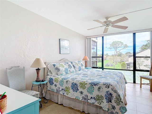 618 Bird Bay Dr S Unit 202, Venice, FL 34285 - bedroom featuring floor to ceiling windows, a textured wall, and a ceiling fan