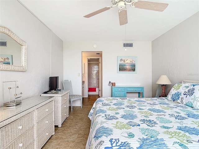 tiled bedroom featuring ceiling fan