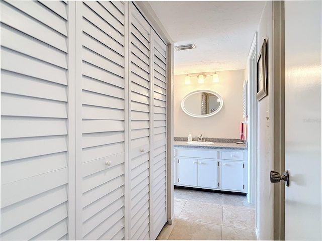 bathroom with tile patterned flooring and vanity