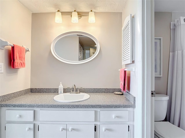 bathroom with vanity and toilet