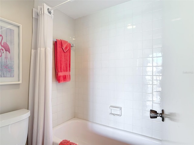 bathroom with toilet and shower / bath combo with shower curtain