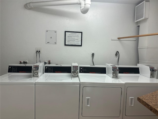 clothes washing area with washer and clothes dryer