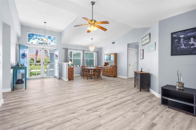 living room featuring light wood-type flooring, ceiling fan, and high vaulted ceiling