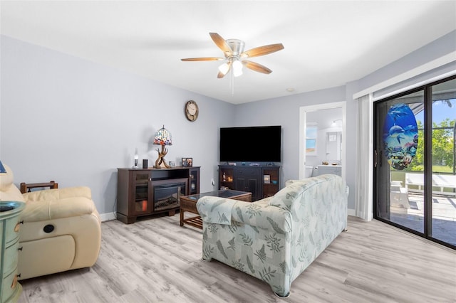 living room featuring light hardwood / wood-style floors and ceiling fan