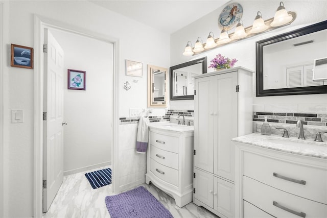 bathroom featuring vanity and tasteful backsplash