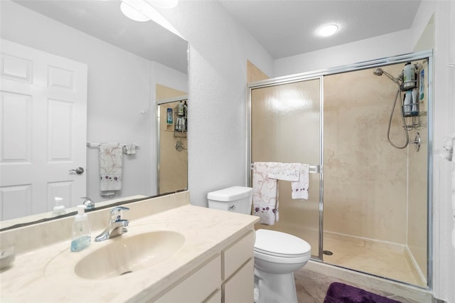 bathroom featuring walk in shower, vanity, and toilet