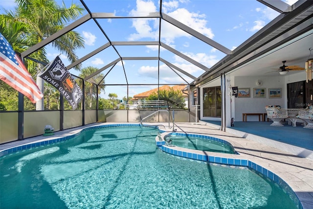 view of swimming pool with a patio, a lanai, and ceiling fan