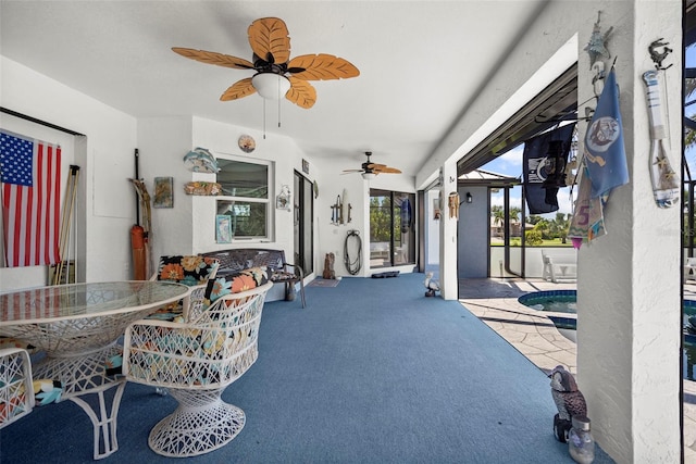 exterior space featuring ceiling fan