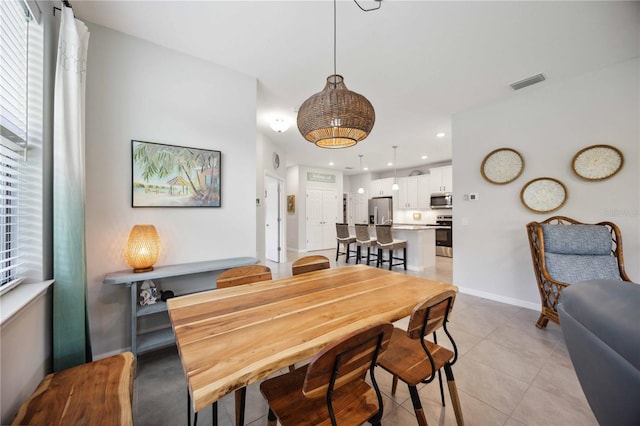 dining space featuring light tile patterned flooring