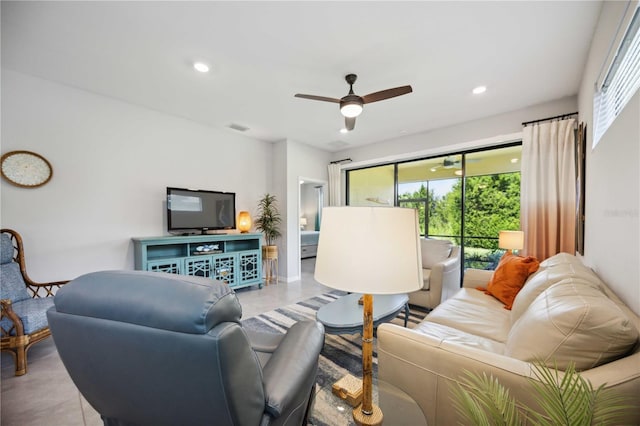 living room with ceiling fan, light tile patterned floors, and a healthy amount of sunlight