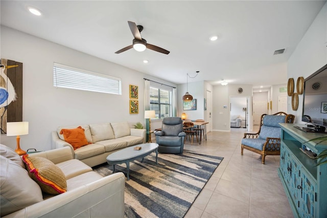 tiled living room with ceiling fan