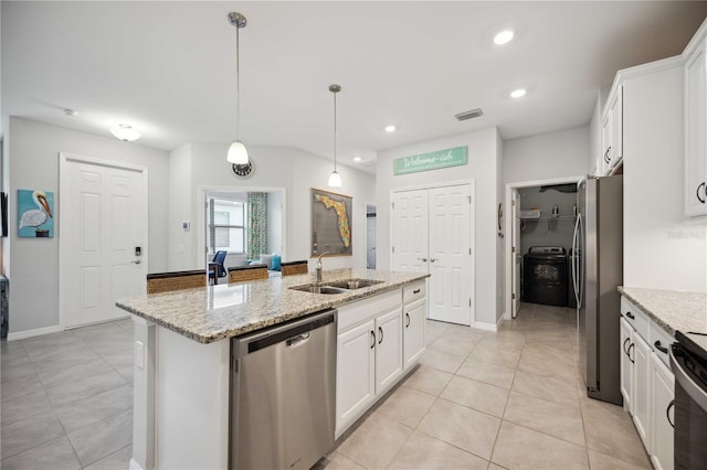 kitchen with white cabinetry, an island with sink, light stone counters, pendant lighting, and stainless steel appliances