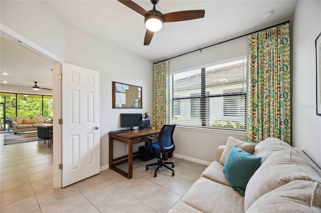 office area featuring a wealth of natural light, ceiling fan, and light tile patterned floors