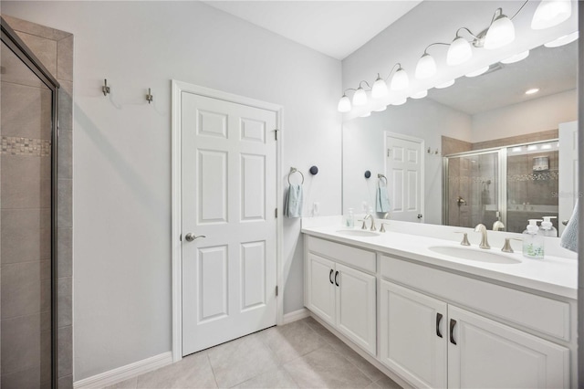 bathroom featuring vanity, a shower with shower door, and tile patterned flooring