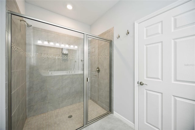 bathroom featuring walk in shower and tile patterned flooring