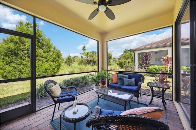 sunroom featuring ceiling fan