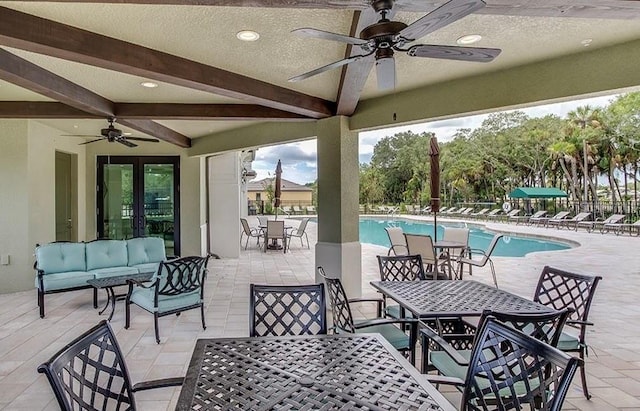 view of patio / terrace with an outdoor hangout area, ceiling fan, and a community pool