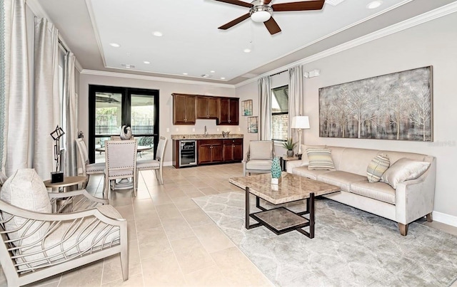 living room with wine cooler, ceiling fan, light tile patterned floors, and crown molding