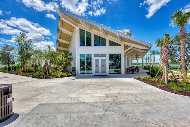 back of property featuring french doors and central AC