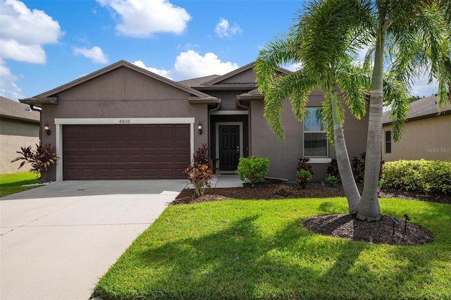 view of front of house with a front lawn and a garage