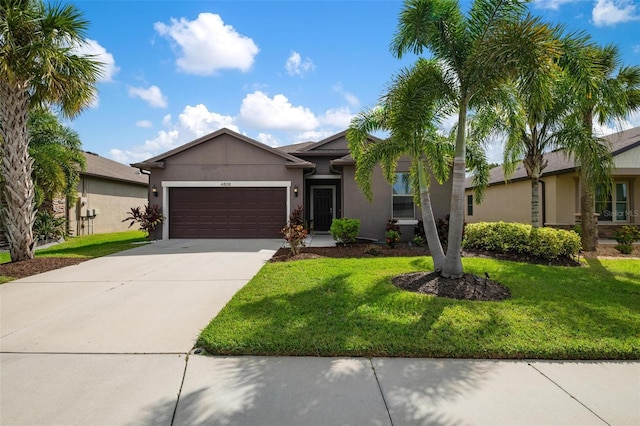 view of front of home featuring a front yard and a garage