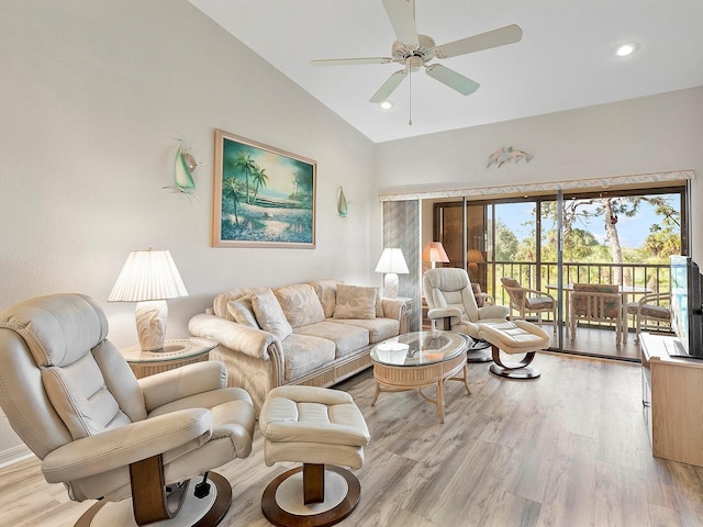 living room with lofted ceiling, ceiling fan, and light hardwood / wood-style flooring