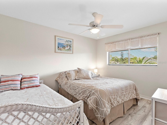 bedroom featuring light hardwood / wood-style floors and ceiling fan