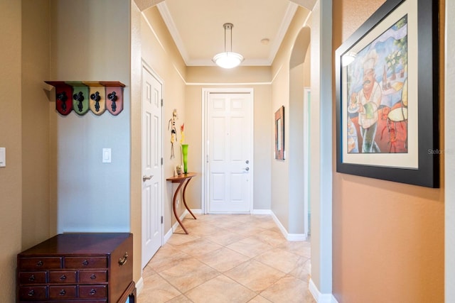 corridor featuring light tile patterned flooring, baseboards, and crown molding