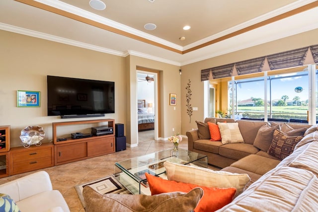 living room featuring a raised ceiling, ornamental molding, and baseboards
