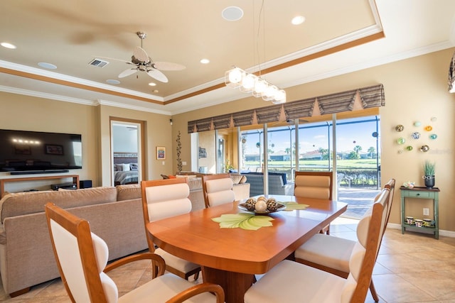 dining area featuring a ceiling fan, a raised ceiling, crown molding, and visible vents