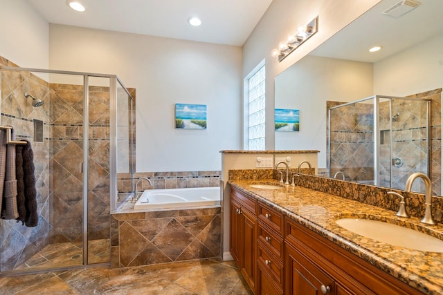 bathroom with independent shower and bath and vanity