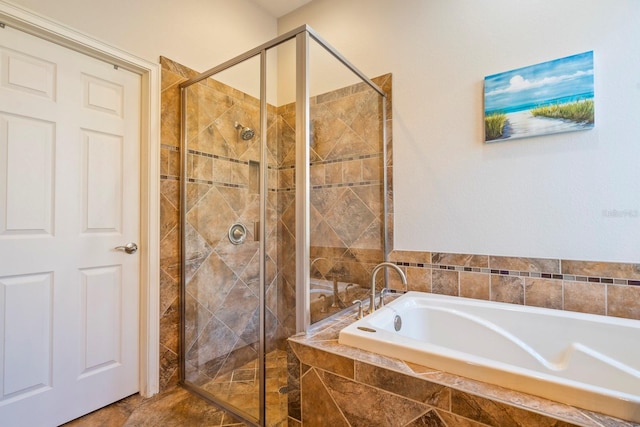 bathroom with a stall shower and a garden tub