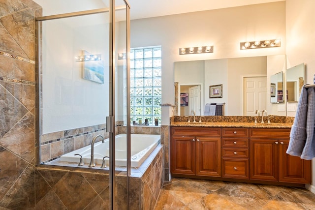 bathroom featuring shower with separate bathtub and vanity