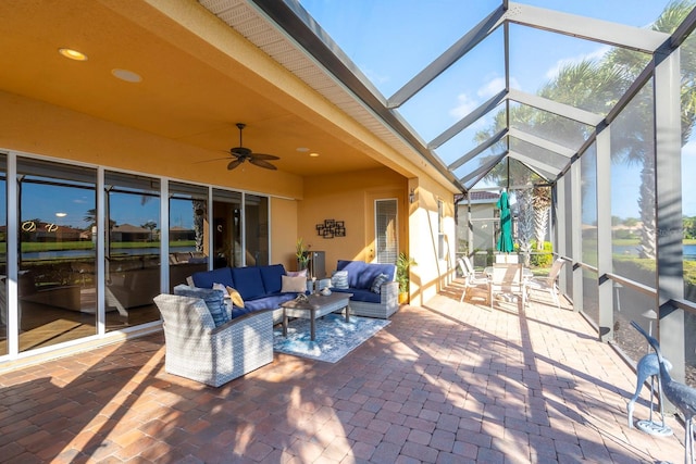 sunroom featuring outdoor lounge area and ceiling fan
