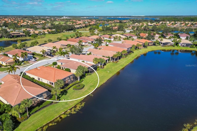 bird's eye view featuring a water view and a residential view