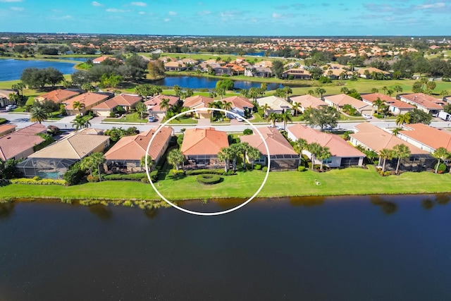 birds eye view of property featuring a water view and a residential view