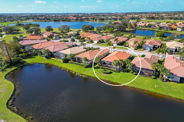 birds eye view of property featuring a residential view and a water view