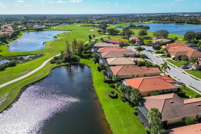 bird's eye view featuring a water view, view of golf course, and a residential view