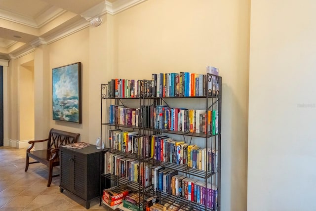 living area with decorative columns, crown molding, and tile patterned flooring