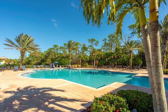 pool with fence and a patio